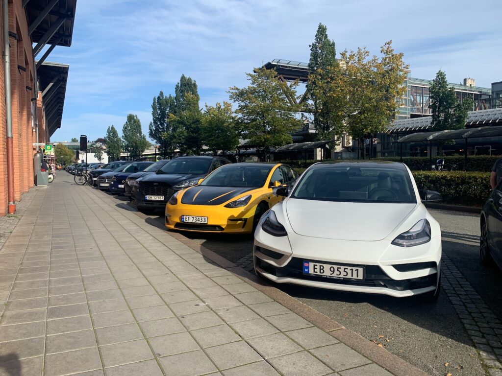 a row of cars parked on the side of a road